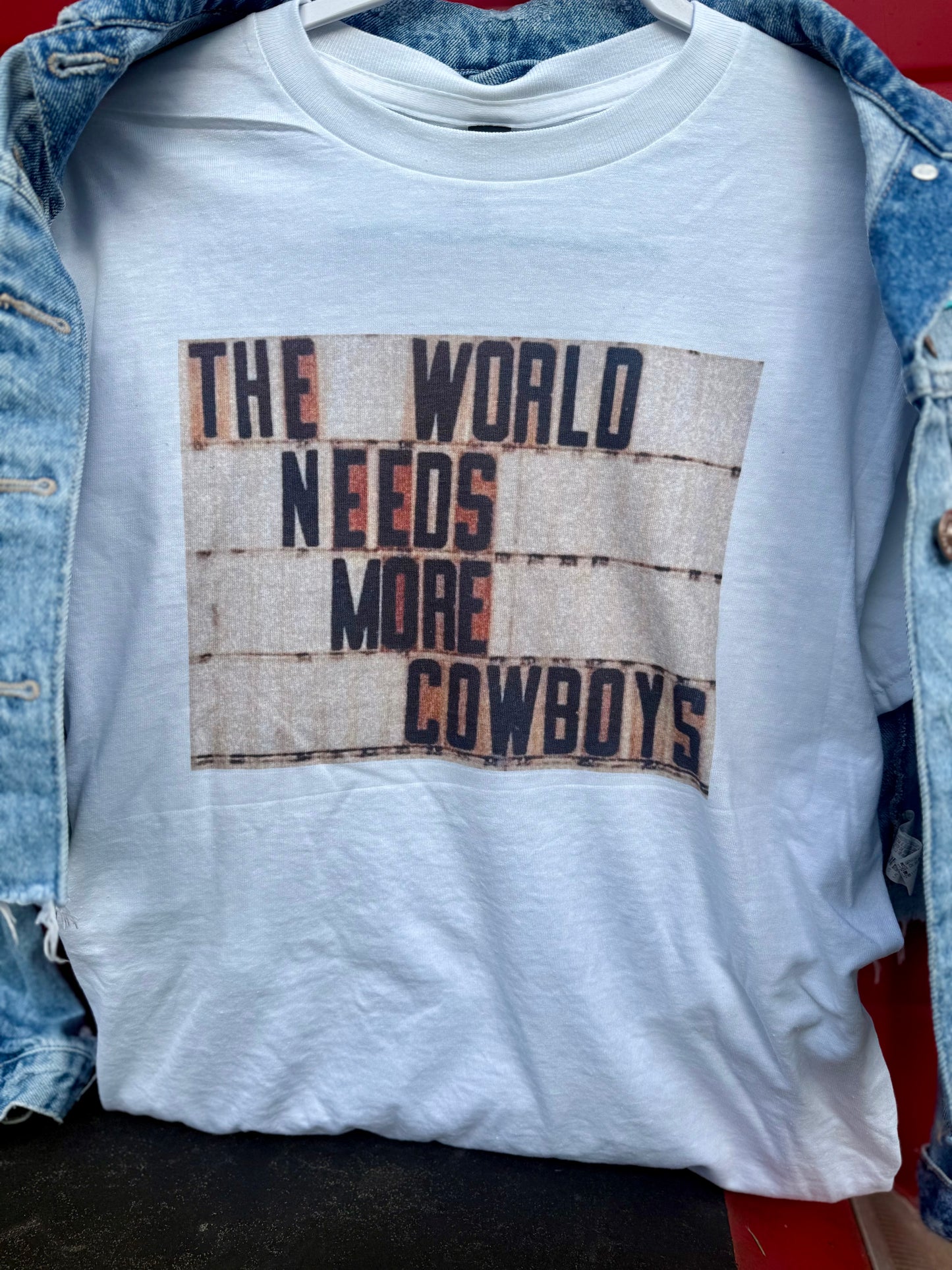 The World Needs Cowboys Tees