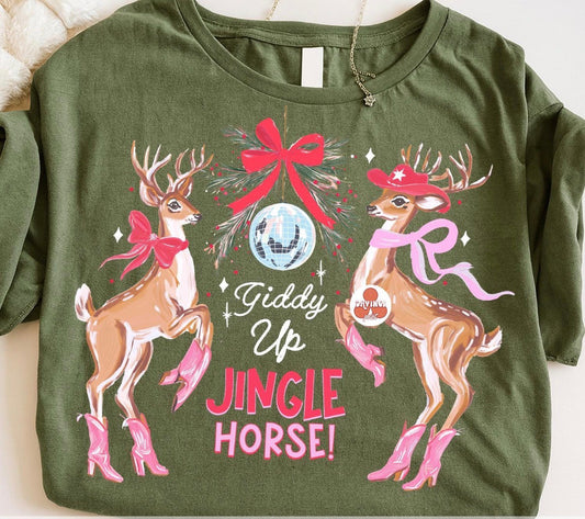 Olive green Giddy Up Jingle Horse Christmas graphic tee featuring reindeer in pink cowboy boots, bows, and a disco ball.